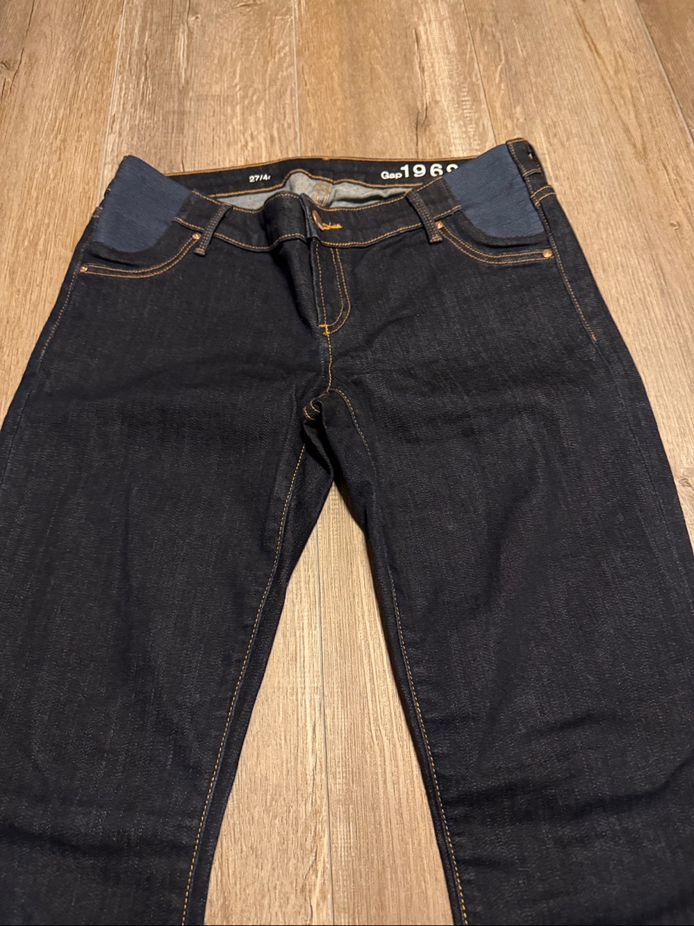 Gap 1969 dark wash maternity jeans featuring stretch side panels for comfort.